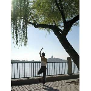  Young Woman in Her 20s to 30s Doing Yoga Beside a Lake 