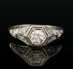   filigree ring set in the center with a round cut diamond weighting an