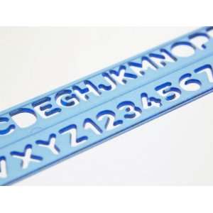  Blue Ruler Against White Background with Tracing of Alphabet 