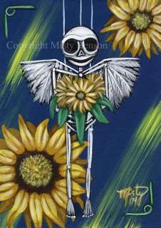 the little skeleton puppet holds her adoring sunflowers as they