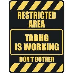   RESTRICTED AREA TADHG IS WORKING  PARKING SIGN