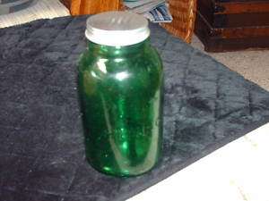 GREEN GLASS BOTTLE WITH TIN SCREW ON LID SAYS LIGHTNING  